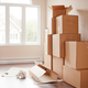 Stacks of moving boxes in a sunny room